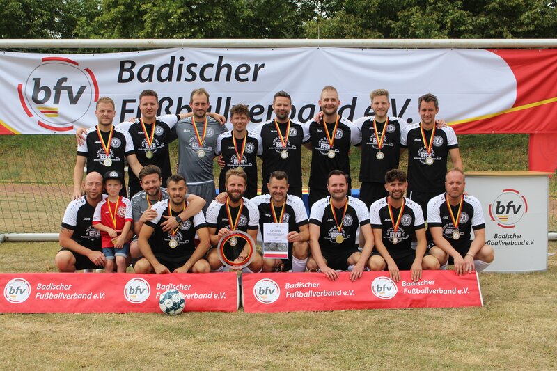 Stolze Männer und Frauen präsentieren ihre Medaillen in einer gemeinsamen Pose.